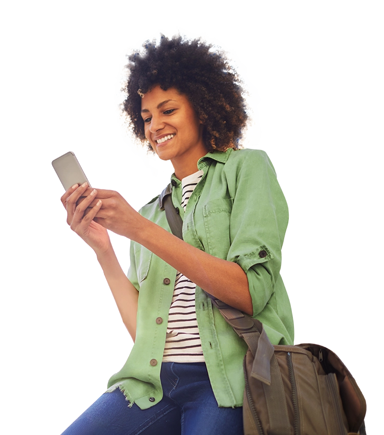 Woman in casual clothes sitting halfway up and smiling at her cell phone.