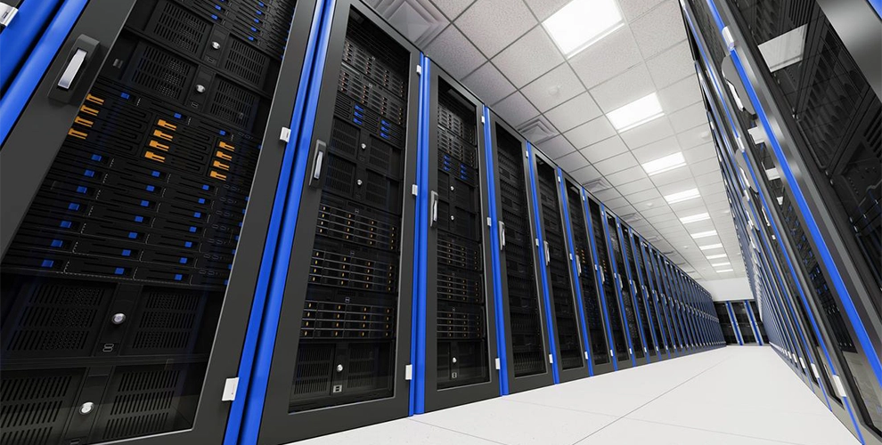 Illuminated data center with rows of servers.